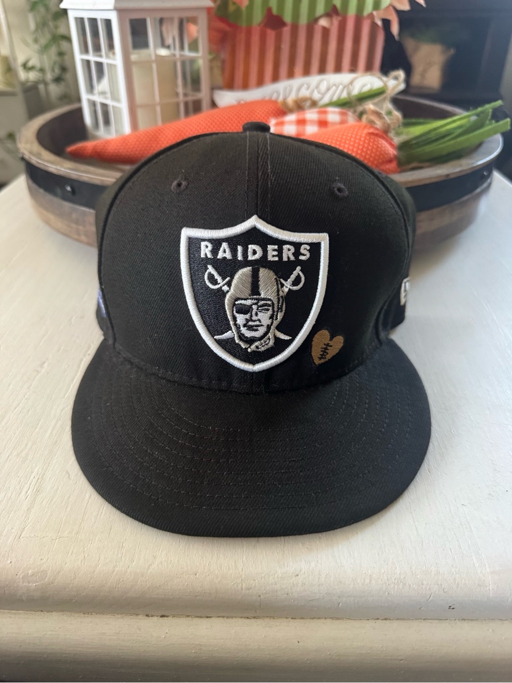 New Era Black Raiders Fitted Hat with White Logo and Gold Heart Accent